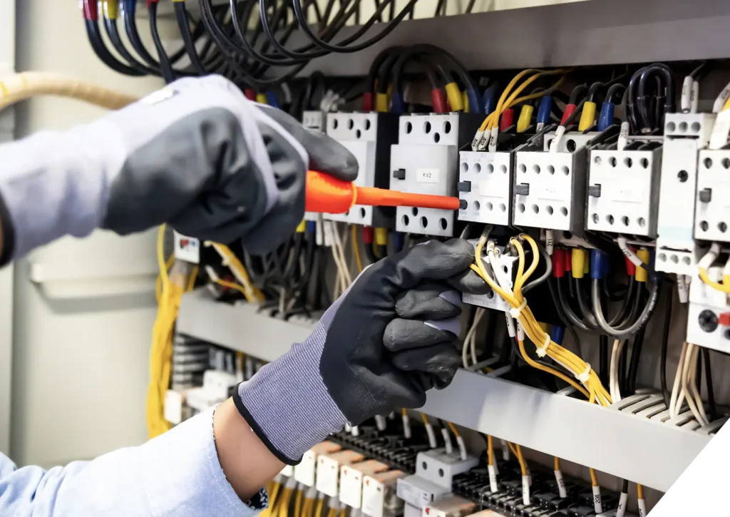 Reliable Home Comfort technician inspecting commercial electrical panel – expert Commercial Electrical Services in Los Angeles.