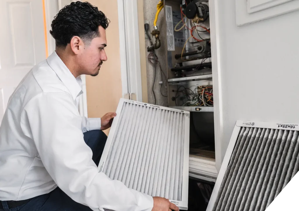 Reliable Home Comfort technician replacing residential HVAC air filters – Furnace Installation & Replacement in Los Angeles.
