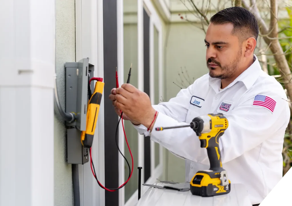 Reliable Home Comfort technician performing electrical diagnostics outside residential property – licensed general electrician services in Los Angeles.