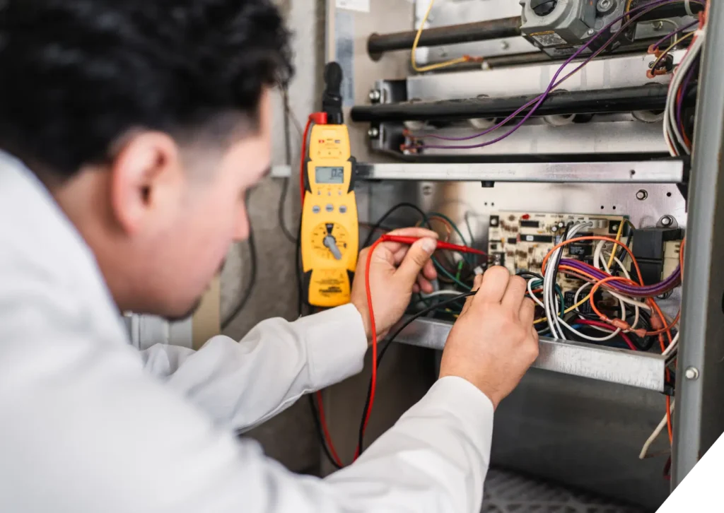 Reliable Home Comfort technician troubleshooting internal HVAC wiring – Heating Maintenance & repair in Los Angeles.